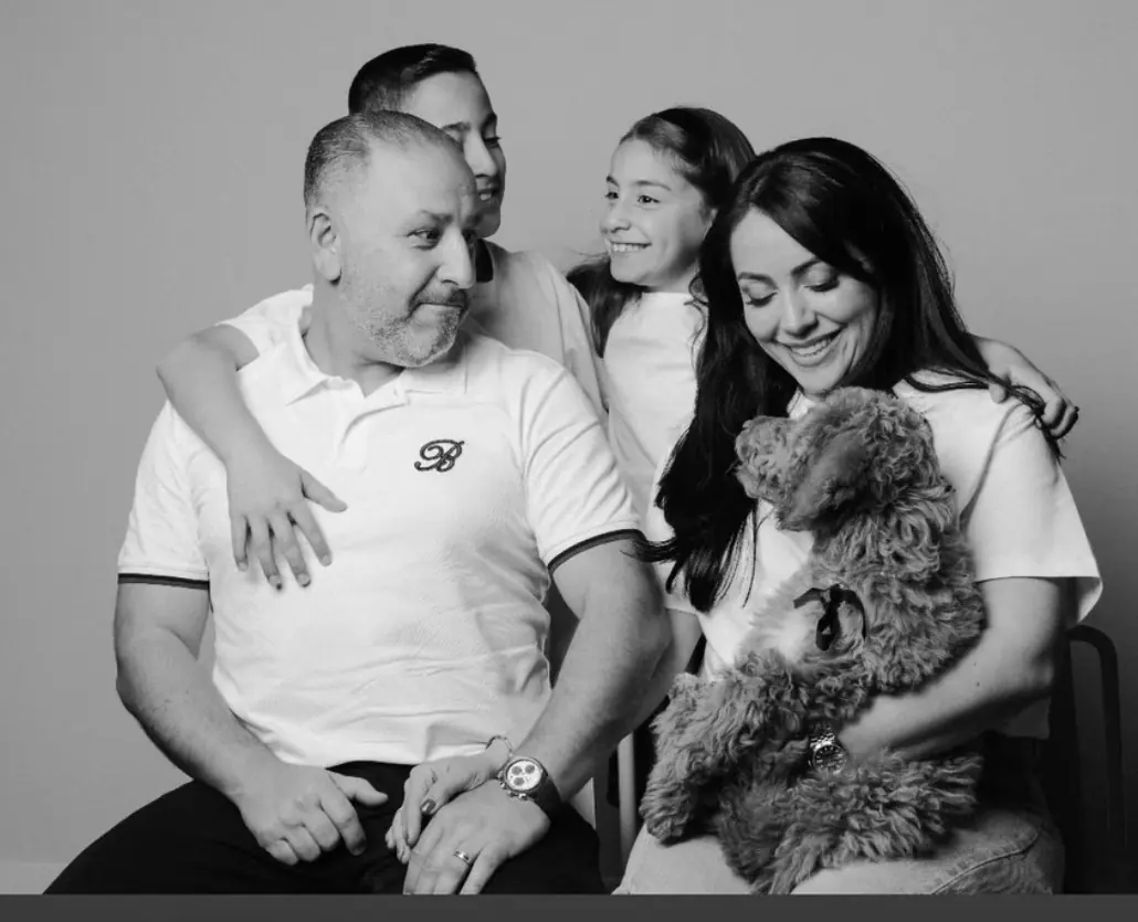A Kid's Best Doodle family sharing a quiet moment at home with their home-raised Goldendoodle